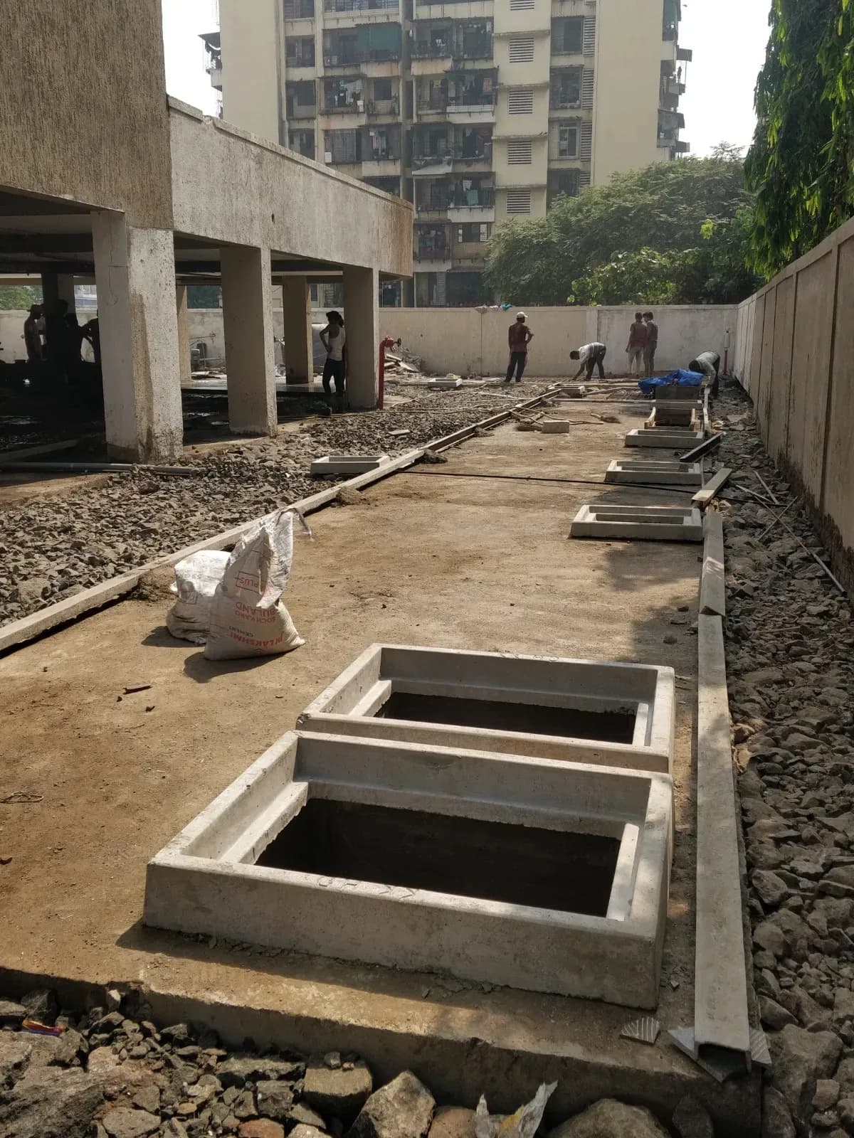 Reinforced concrete tank structures and pipework under construction at a sewage treatment plant