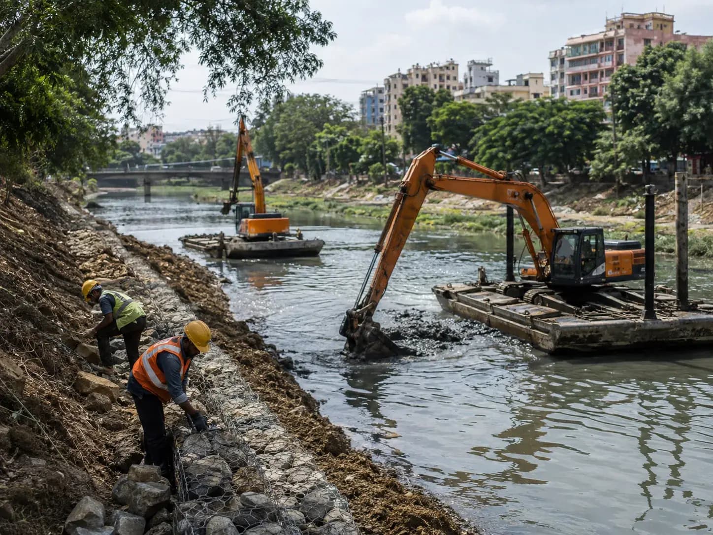 river and nalah rejuvenation in progress with desilting machinery and bank resto