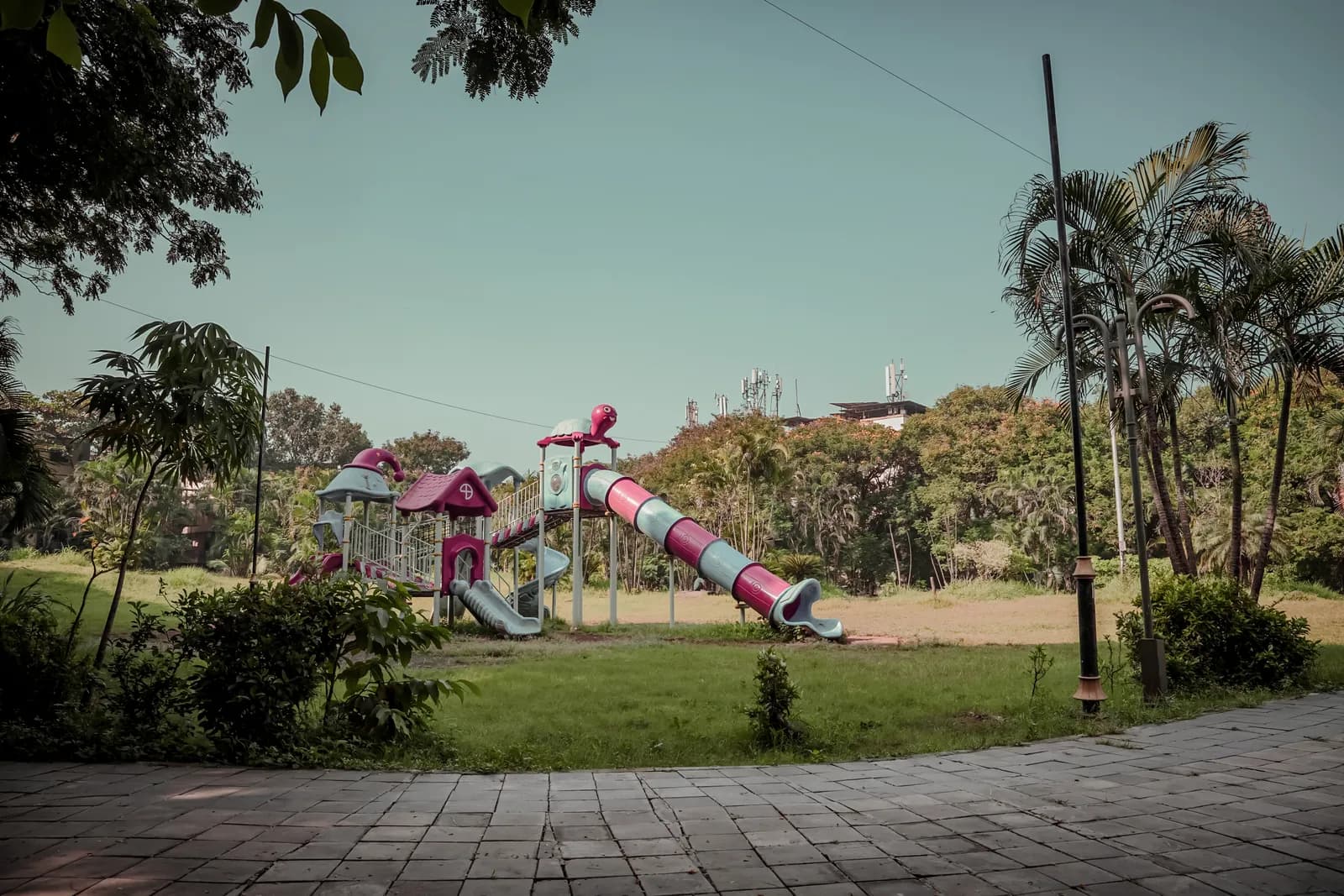 The finished landscaped recreational space at Kalamboli Sector 2: play equipment, walkways and planting