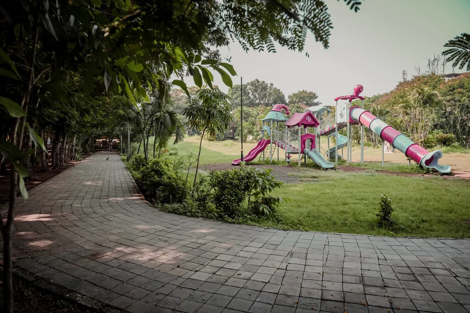The finished landscaped recreational space at Kalamboli Sector 2: play equipment, walkways and planting