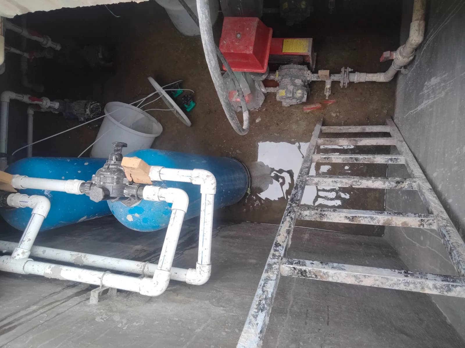 Reinforced concrete tank structures and pipework under construction at a sewage treatment plant