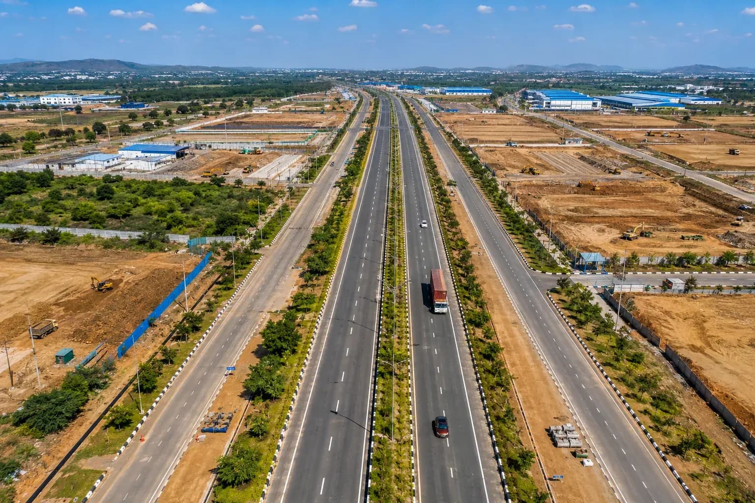 Aerial view of a divided highway through an industrial corridor