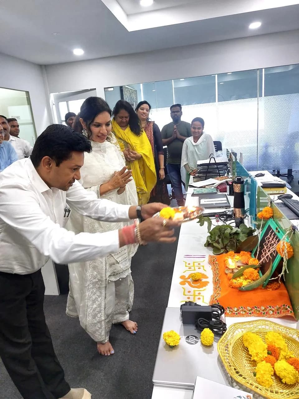 Marigolds and puja offerings laid over office equipment for Dussehra