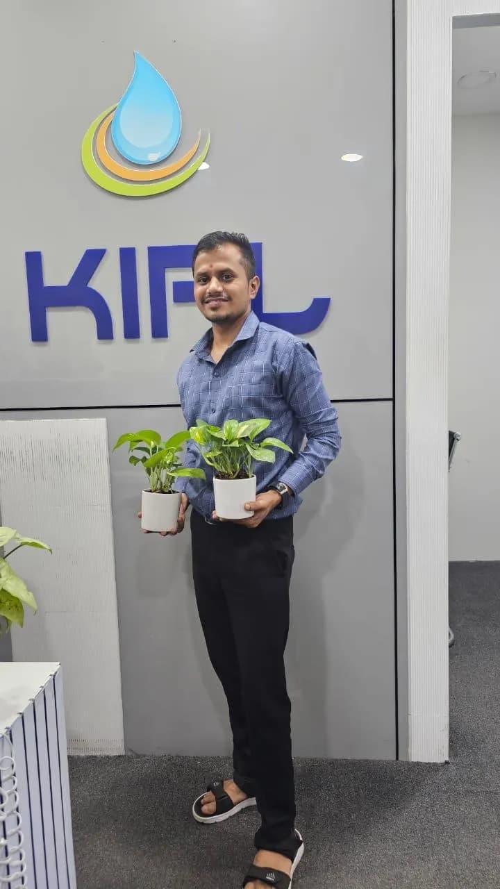 KIPL colleagues holding potted saplings on World Environment Day