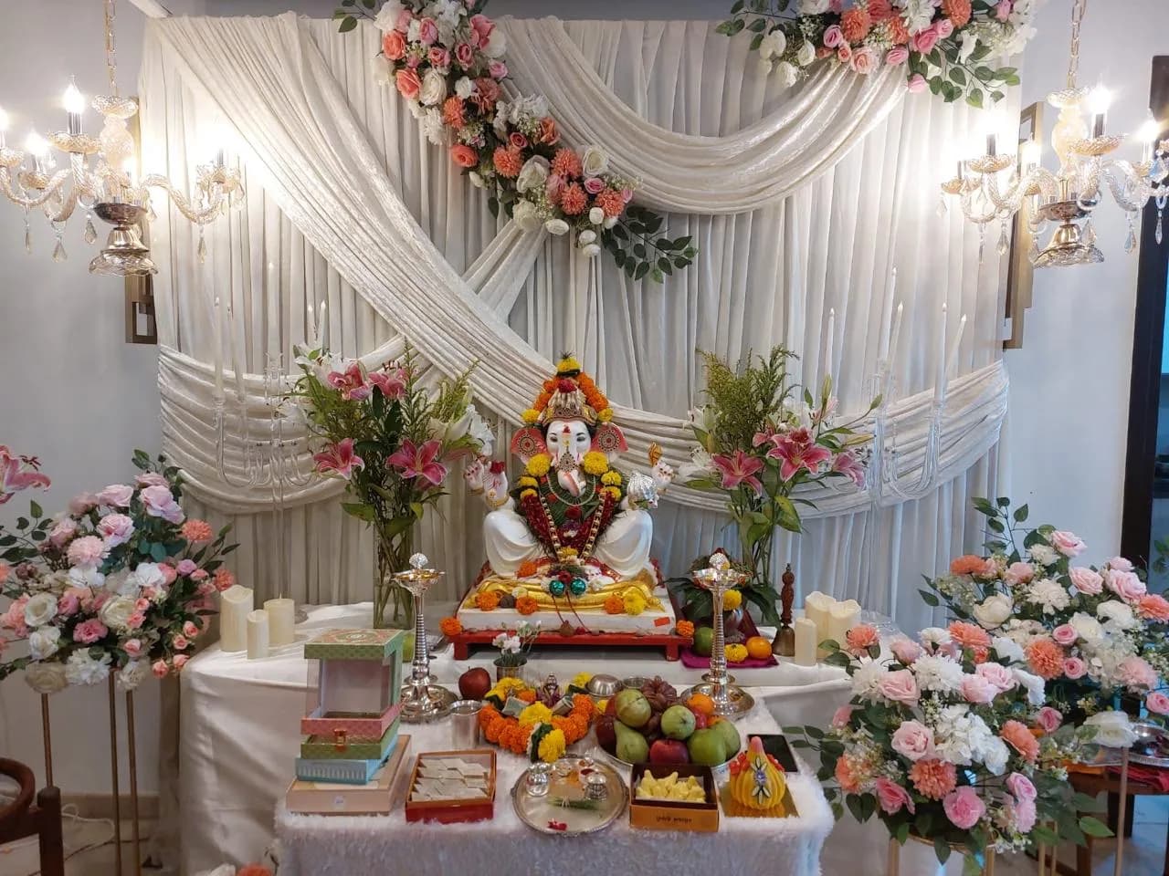 KIPL colleagues gathered around the decorated Ganpati idol at the office