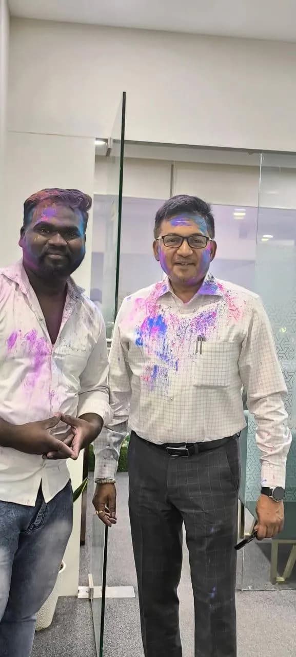 KIPL colleagues covered in coloured powder at the office Holi