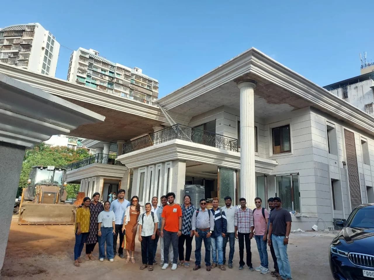 KIPL colleagues outside a completed building at Kharghar